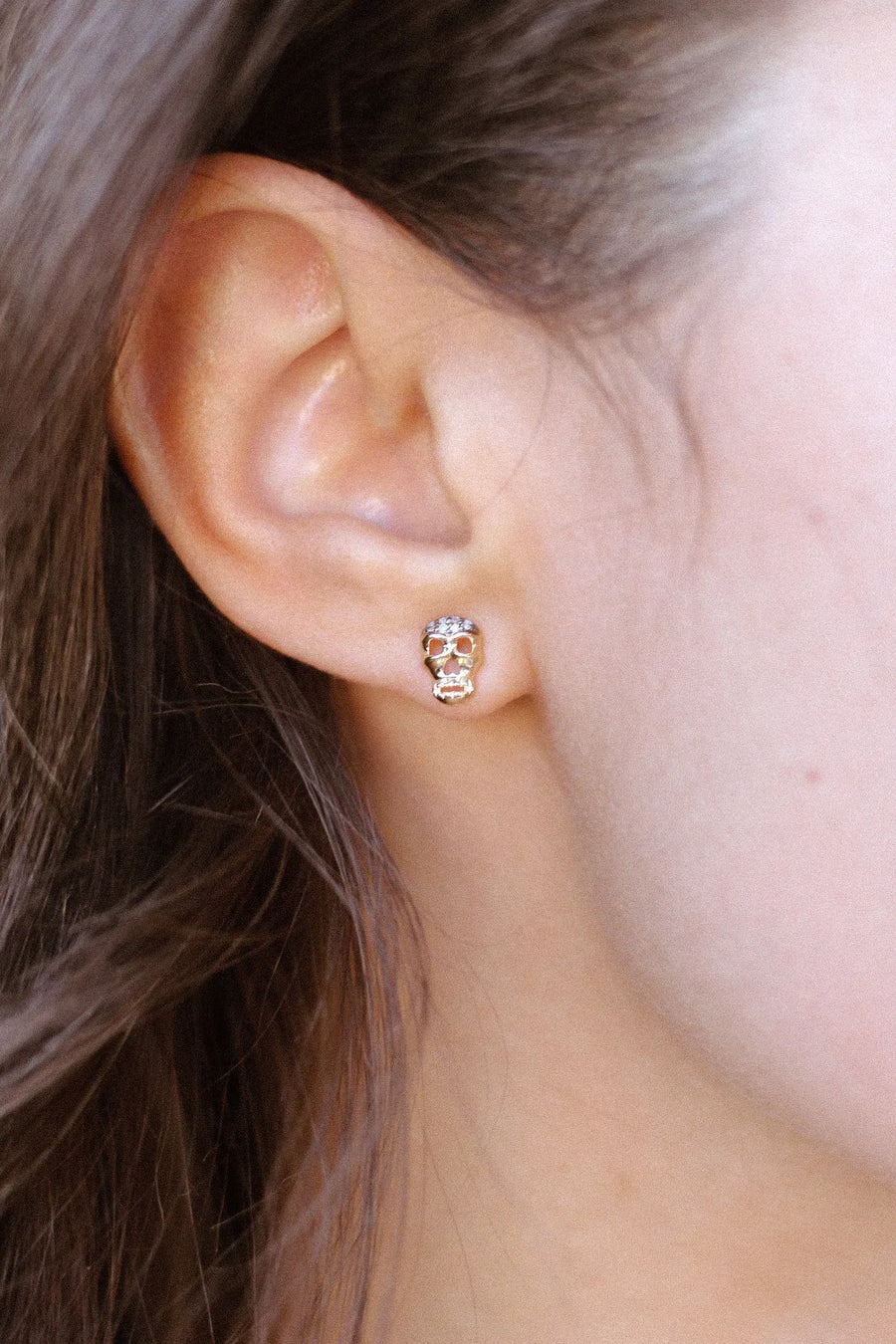 Petite Skull Post Earrings with White & Black Diamonds - White Gold On Ear