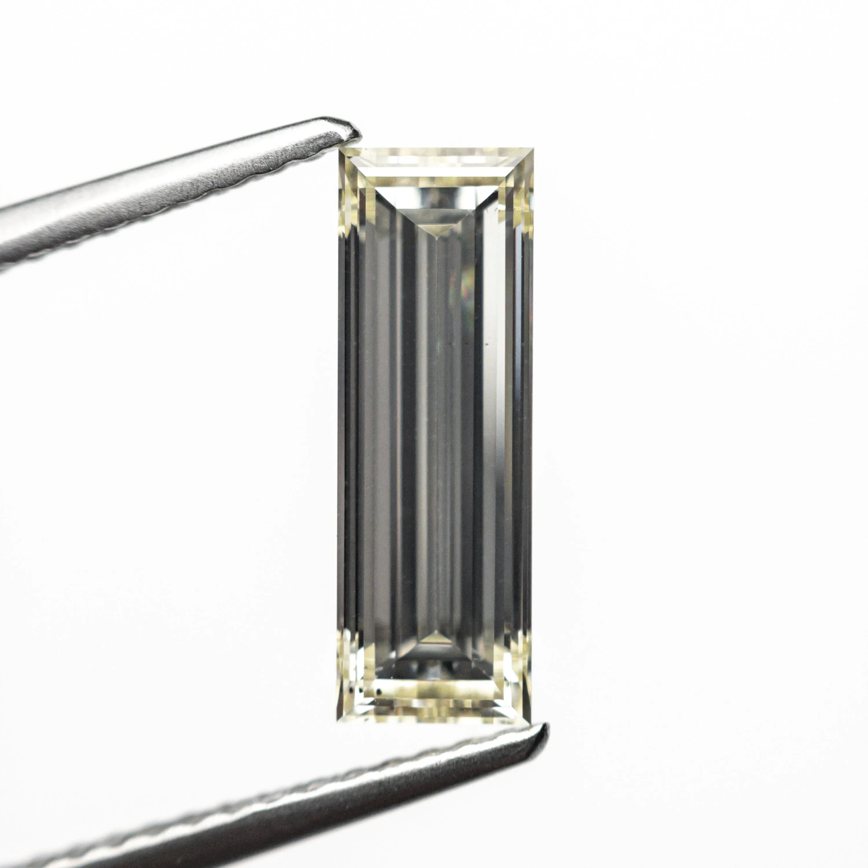 1.52ct 12.21x4.16x2.86mm VS2 O-P Baguette Step Cut 26124-01