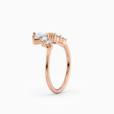 Contoured diamond wedding band featuring pear, round, and baguette diamonds.