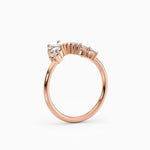 Contoured diamond wedding band featuring pear, round, and baguette diamonds.