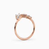 Contoured diamond wedding band featuring pear, round, and baguette diamonds.