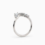 Contoured diamond wedding band featuring pear, round, and baguette diamonds.