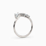 Contoured diamond wedding band featuring pear, round, and baguette diamonds.